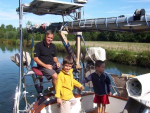 kids learning to steer the boat in the Canals in Europe 